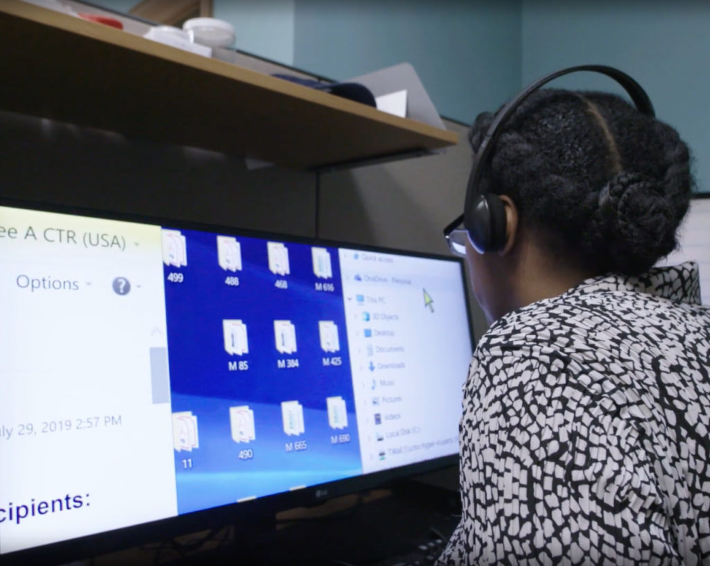 woman with headset using computer